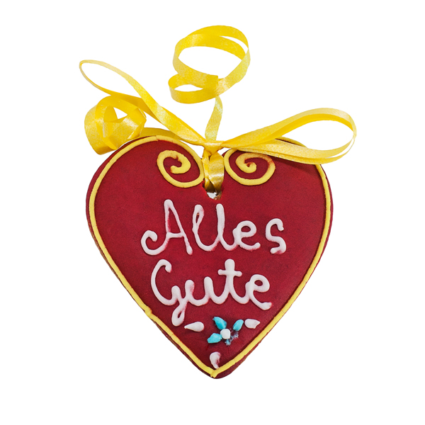 Rotes Lebkuchenherz mit gelber Schleife und der handverzierten Aufschrift „Alles Gute“